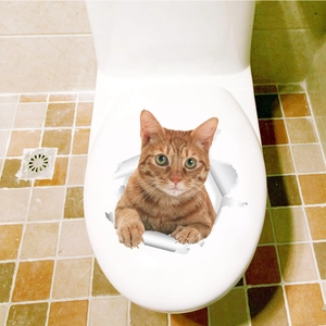 Detail of 3D orange tabby cat sticker peeking through torn paper hole on a white toilet seat