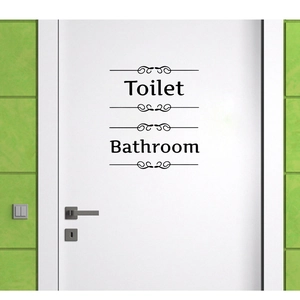 Minimalist black vinyl wall stickers featuring Toilet and Bathroom lettering with elegant scrolls