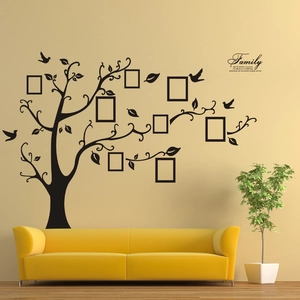 Black family tree wall sticker with 9 photo frames and quote on a living room wall