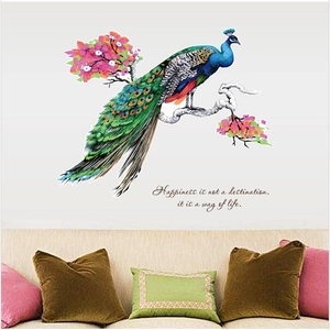 Detail of colorful peacock wall sticker with floral design and motivational text on living wall
