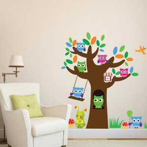 Forest themed wall decal with owls and tree in a modern kids room setting