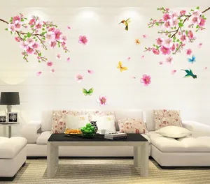 Modern living room wall stickers featuring pink peach blossoms and colorful hummingbirds