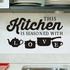 Kitchen wall decal featuring 'Seasoned with Love' text and utensil icons on a tiled wall