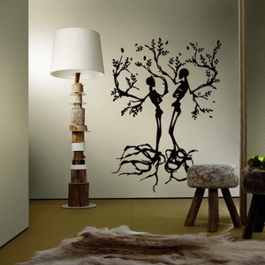 Artistic black tree of life wall decal with skull elements in a cozy living room scene