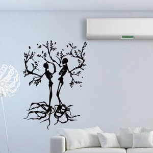 Gothic skull tree wall decal displayed above a modern white sofa in a minimalist living room