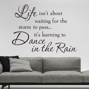 Inspirational 'Dance in the Rain' quote wall sticker on a modern grey living room wall