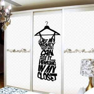 Dettaglio dell'adesivo murale silhouette vestito nero con citazione di moda su armadio