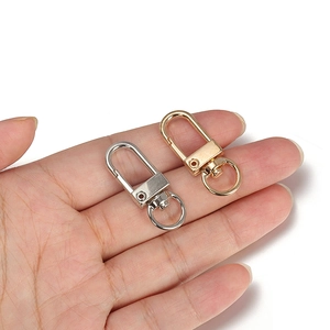 Golden and silver alloy lobster clasps for DIY jewelry making shown in hand for scale