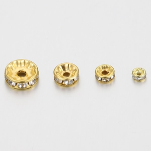 Golden rhinestone spacer beads in four sizes for DIY jewelry making on white background