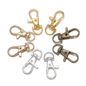 Detailed macro view of swivel lobster clasps in four metallic finishes for DIY jewelry projects