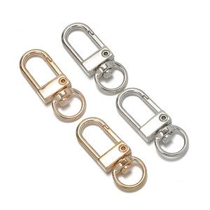 Detail of four metal swivel lobster clasps in gold and silver finish for jewelry making