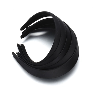 Set of five black matte fabric wide headbands shown in a stacked top-down view