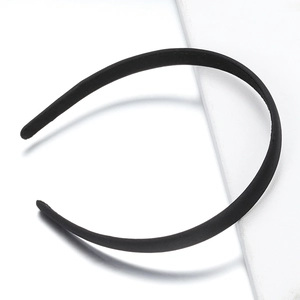 Minimalist matte black fabric headband for women shown on a clean white aesthetic background