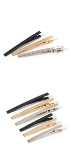 Detail of long metal alligator hair clips in gold, silver, and black plating finishes