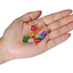 Colorful hollow metal hair rings for dreadlocks and braids shown on person's hand