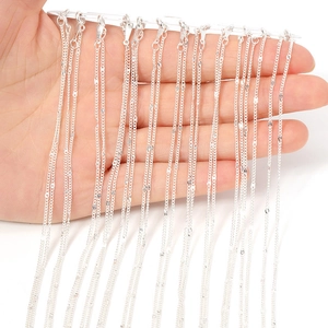 Close-up of silver metal twist chains for DIY jewelry making held by hand on white background