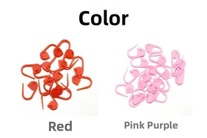 Close-up of red and pink purple plastic knitting stitch markers for DIY crochet crafts