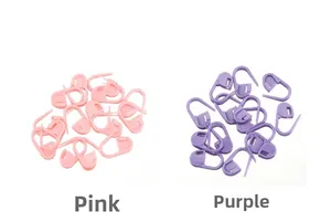 Close-up of pink and purple plastic stitch markers for knitting and DIY crochet tools