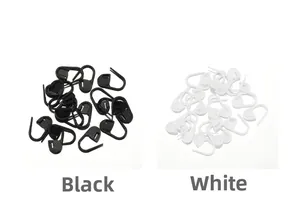 Close-up of black and white plastic safety stitch markers for knitting and DIY sewing crafts