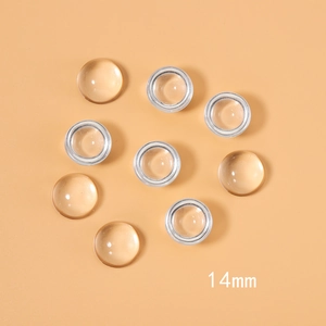 Λεπτομέρεια από στρογγυλά γυάλινα cabochon 14mm, διαφανή και κεχριμπαρένια για κοσμήματα