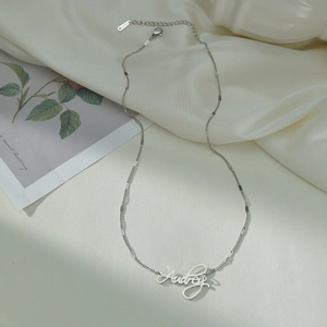 Custom silver Audrey name necklace in stainless steel with minimalist disk chain design