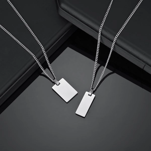 Macro detail of silver rectangle tag pendants with premium polished steel finish