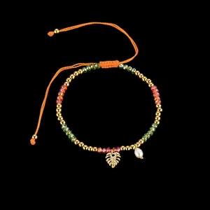 Colorful beaded bracelet with hollow leaf charm and pearl on black background