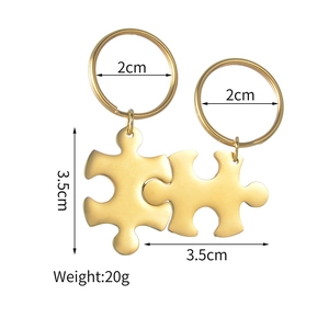 Detailed view of gold puzzle piece keychains with 2cm ring and 3.5cm dimensions