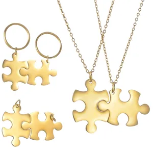 Polished gold puzzle piece jewelry set including necklaces and matching keychains