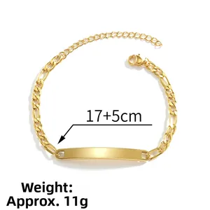 Close-up of golden Figaro chain bracelet with blank ID plate, 17+5cm length with lobster clasp