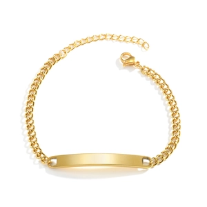 Macro detail of gold-plated cuban link bracelet featuring a polished blank ID bar and lobster clasp