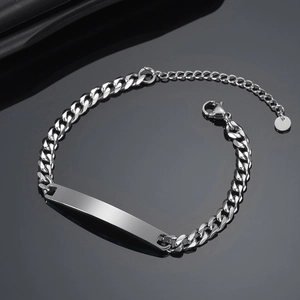 Polished silver stainless steel Cuban link ID bracelet with blank engraving plate detail