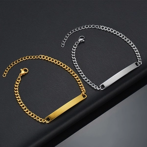 Detail shot of gold and silver cuban chain bracelets with polished engravable curved plates
