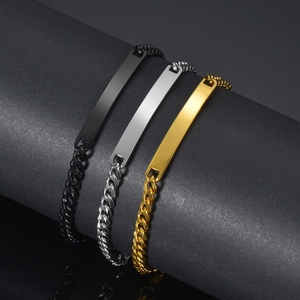 Close-up of three-color stainless steel Cuban ID bracelets in black, gold, and silver