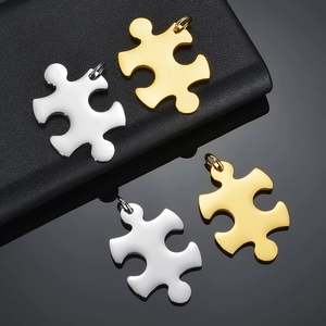 Polished puzzle piece pendants in gold and silver finish on textured display mat