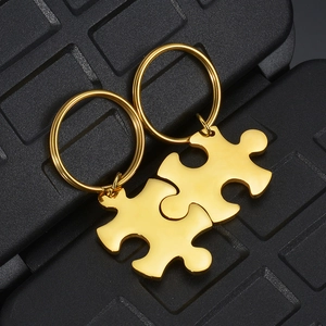 Close-up of interlocking puzzle pendant necklaces in gold-plated stainless steel