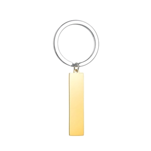 Detailed close-up of a minimalist silver key ring with a polished gold rectangular tag