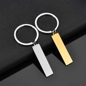 Detailed view of polished gold and silver rectangular stainless steel keychain charms