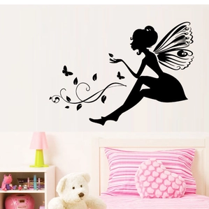 Detail view of black fairy silhouette wall stickers with butterflies in a cozy bedroom