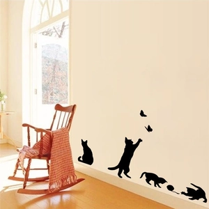 Detail of black cat silhouette wall decals featuring jumping and sitting poses with butterflies