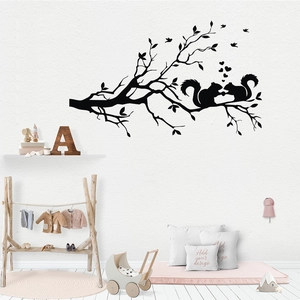 Black silhouette wall decal featuring branches, squirrels, and hearts for room decor
