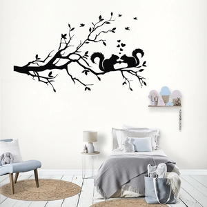 Creative black squirrel silhouette wall sticker on tree branch in a modern nursery room