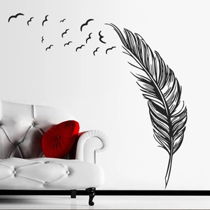 Modern black feather wall decal with birds silhouettes over a white leather sofa