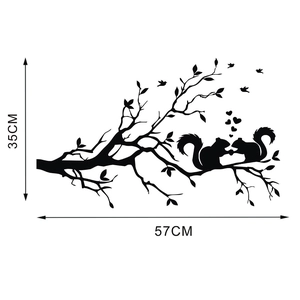 Black silhouette wall sticker of squirrels on a branch with bird and heart accents
