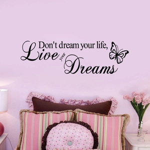 Detail of 'Live Your Dreams' wall sticker with butterfly art in a pink bedroom setting
