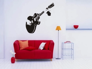 Modern black guitar wall decal featuring a silhouette of a musician for home decor