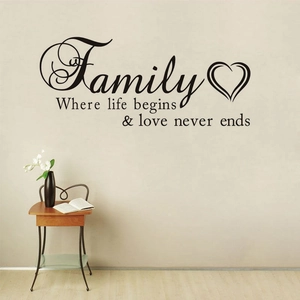 Family quote wall decal featuring elegant black lettering with a heart on a living room wall