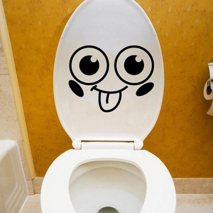 Detail of waterproof smiling cartoon face sticker on toilet lid with macro view