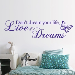 Detail of purple Live Your Dreams wall decal with butterfly accents in bedroom