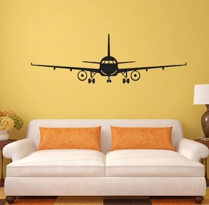 Detailed view of black airplane wall sticker silhouette on a textured living room wall